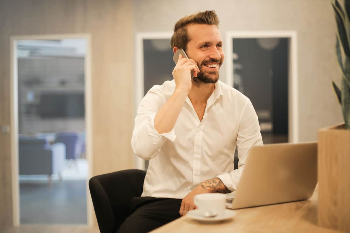 homme au téléphone devant son ordinateur